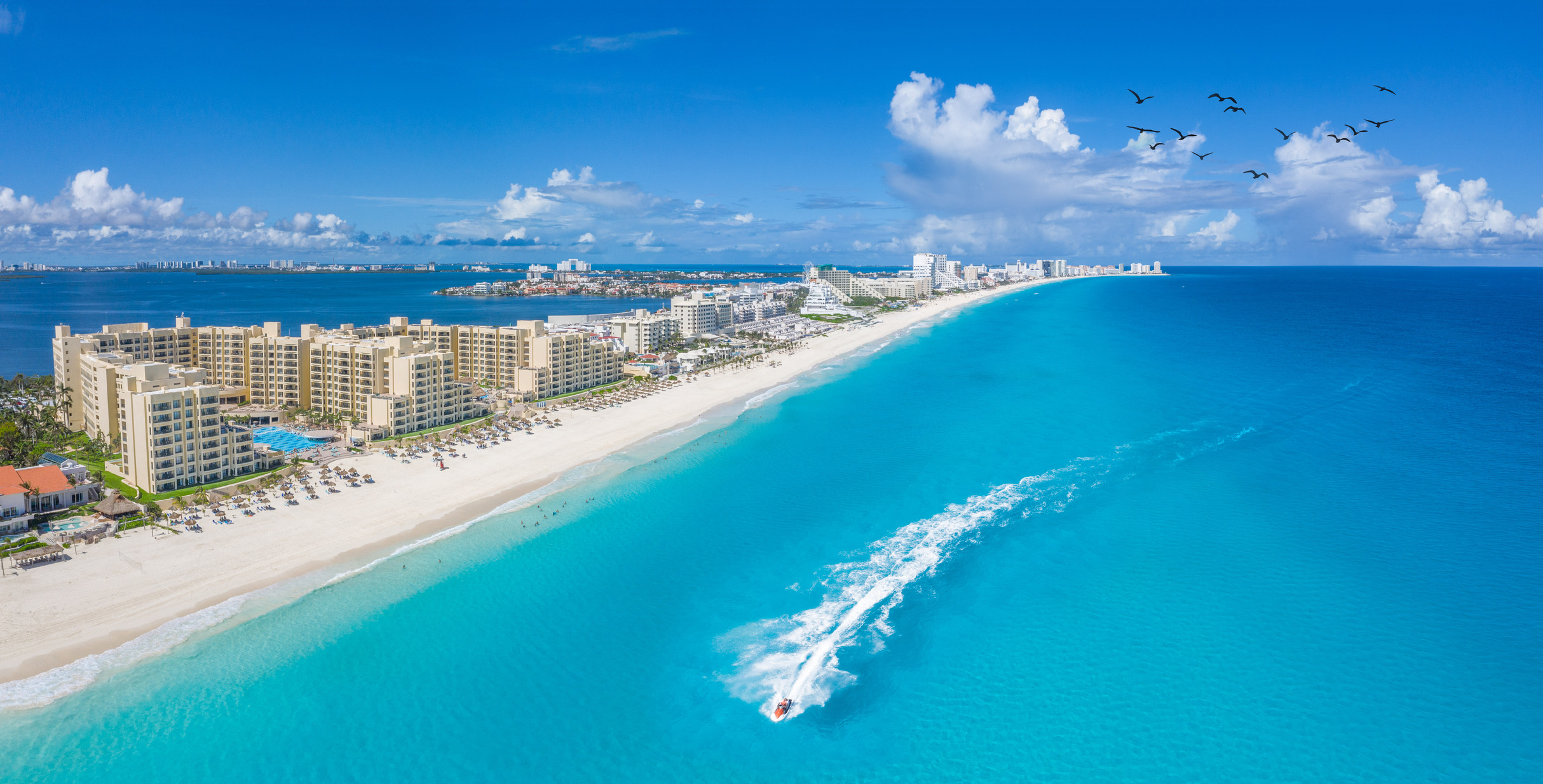 Image of Cancun Beach With Boats And White Clouds