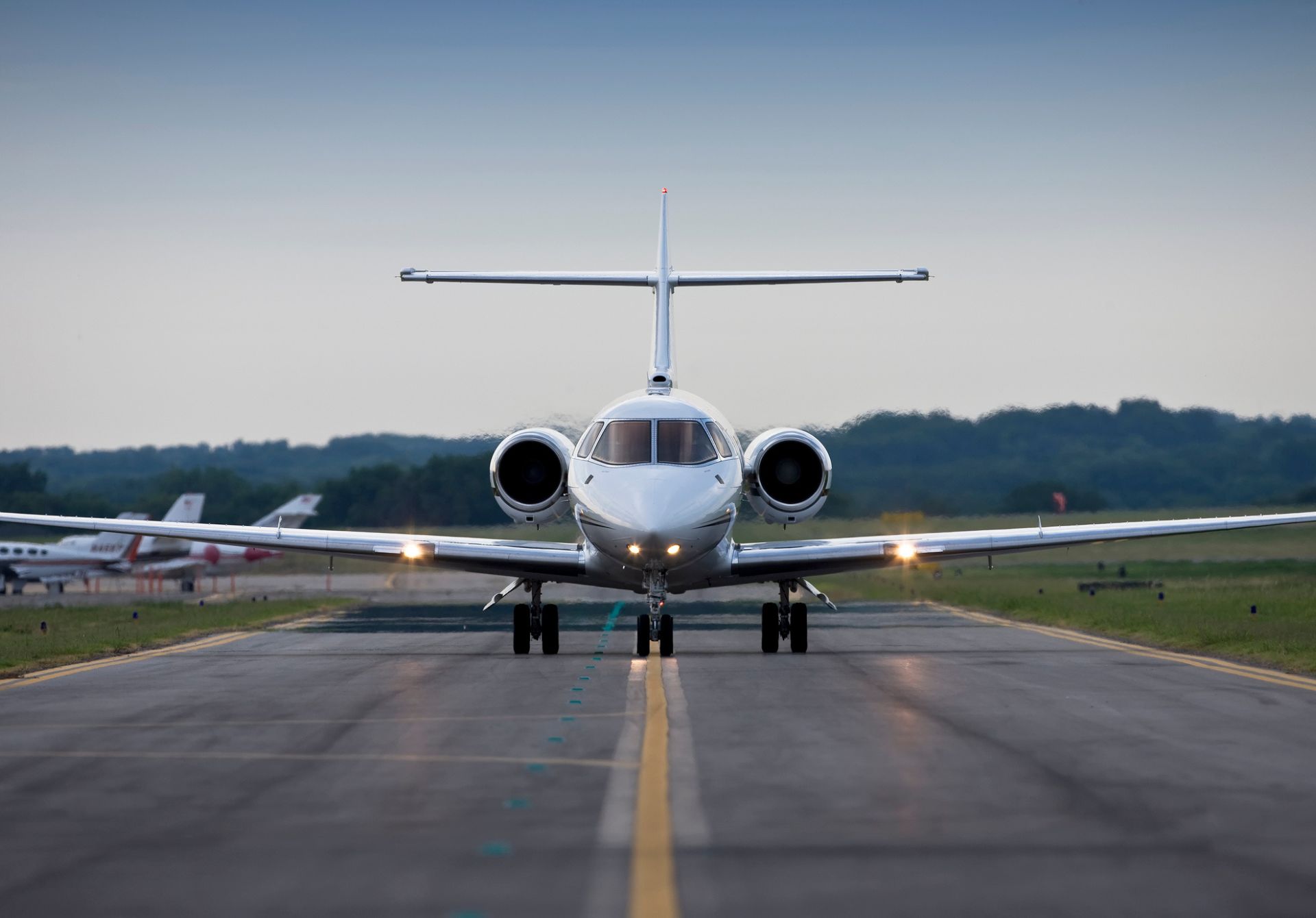 Image of Private Jet Departing On The Runway At Dusk